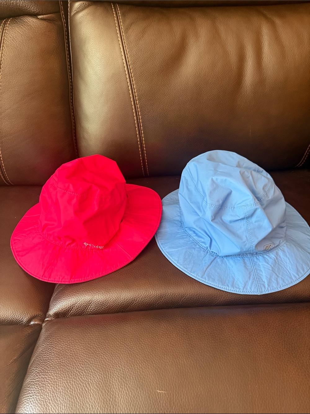 2 Columbia Kids Bucket Hats in Red and Light Blue.